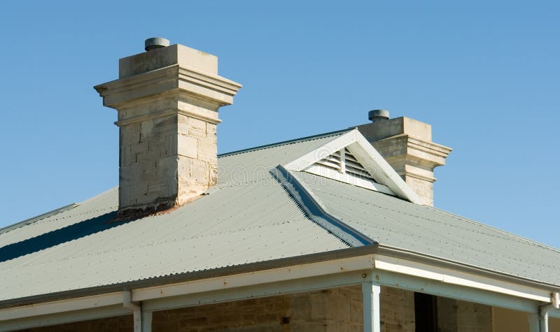 View of house roof line with view to blue sky. View of house roof line in tin with view to blue sky stock photography