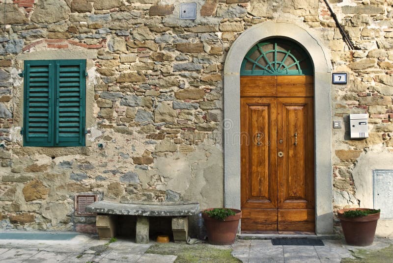 Vintage italian front door. The vintage italian front door of an old house in Tuscany royalty free stock photo