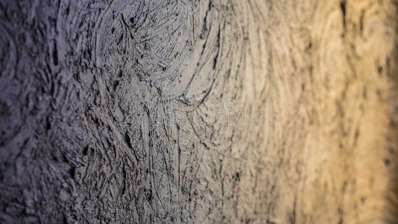 Wall surface with uneven textured plaster rough relief gray colors royalty free stock photo