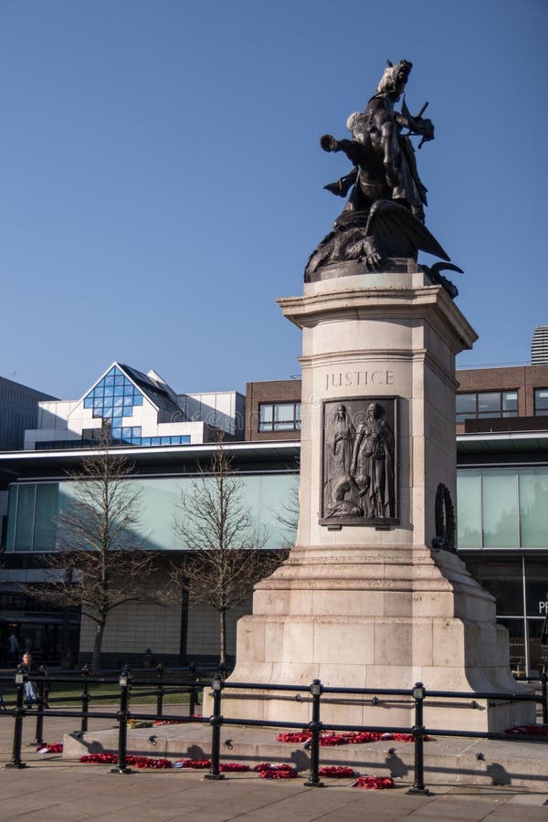 War Memorial bronze statue on stone plinth with poppy wreaths in Old Eldon Square Newcastle upon Tyne. Newcastle / Great Britain : War Memorial bronze statue on stock photos