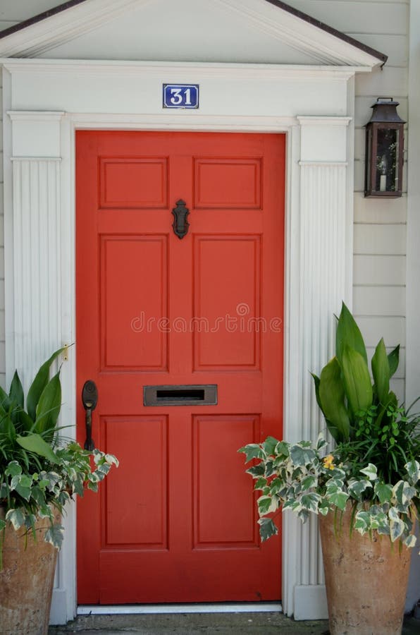 Welcoming Front Door. Pretty orange colonial front door entrance royalty free stock images