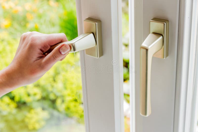 Woman opens window for ventilation royalty free stock image