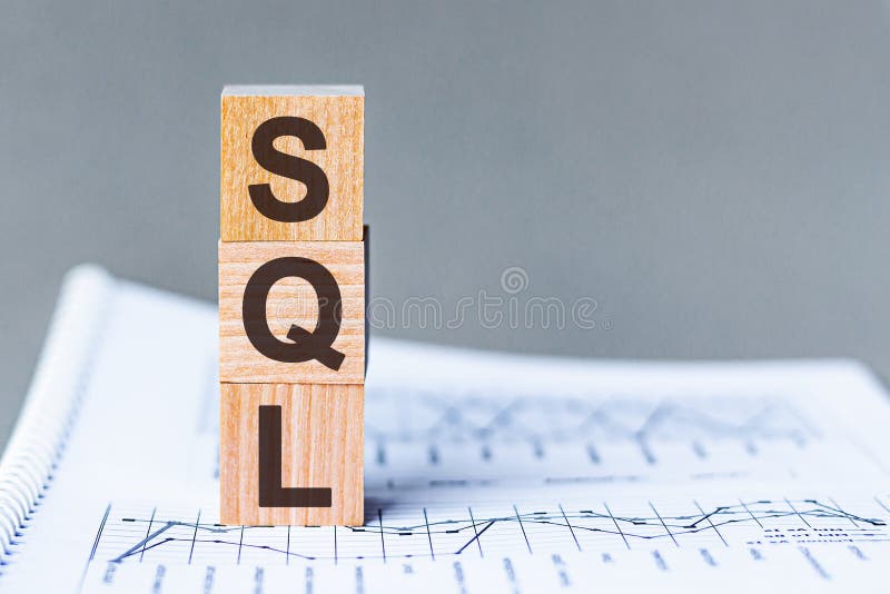 Wooden block with words SQL - acronim SQL - Structured Query Language. SQL wooden blocks on the paper grey background. The word sql structured query language stock photos