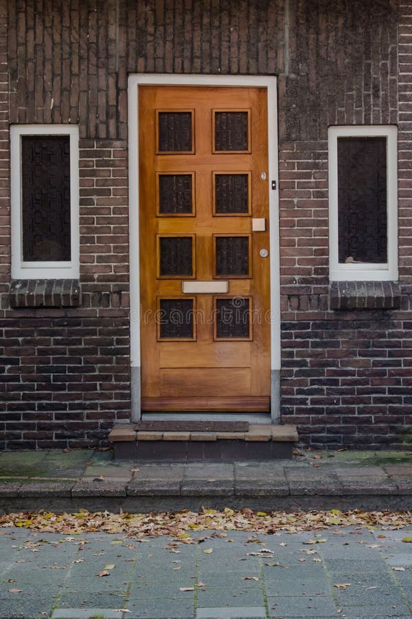 Wooden door and windows in European town stock images