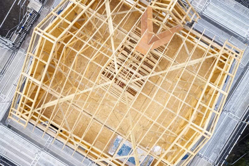 Wooden roof truss beams during construction building of a house aerial view royalty free stock photos