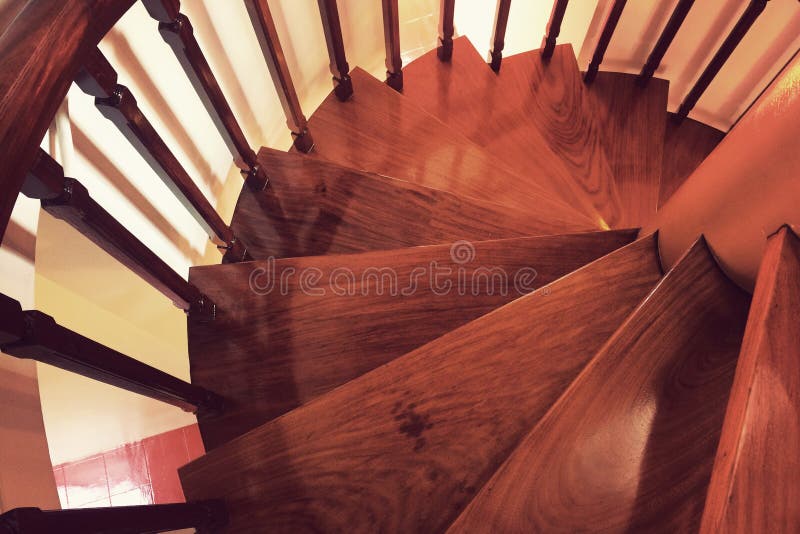 Wooden Spiral staircase made of antique wood stock photo