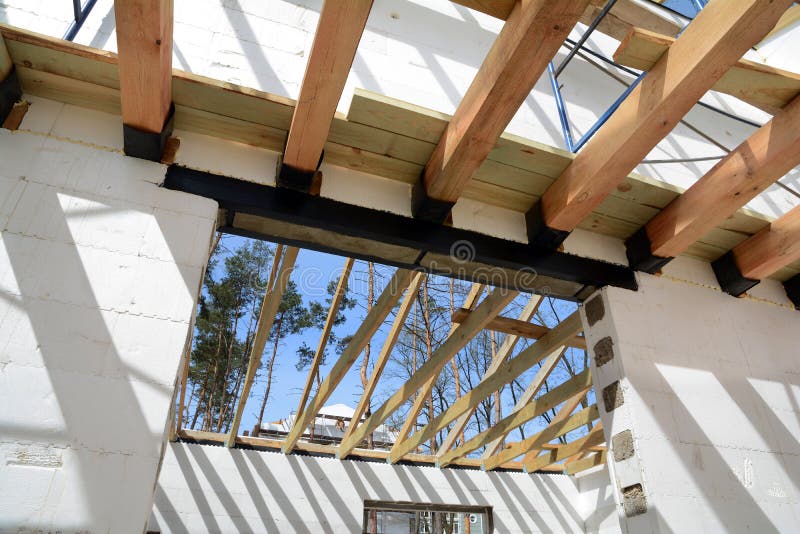 The wooden structure of the building. Installation of wooden beams at construction the roof truss system of the house. royalty free stock photos