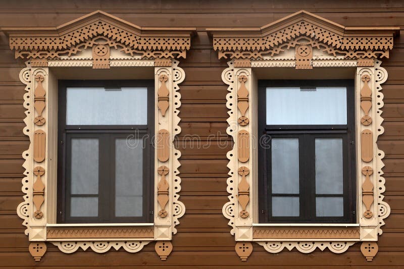 Wooden windows with carved platbands stock images