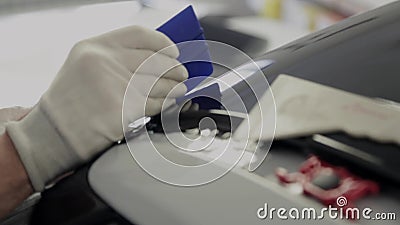 Close up shot of man`s hands removes air bubbles while tuning car stock footage