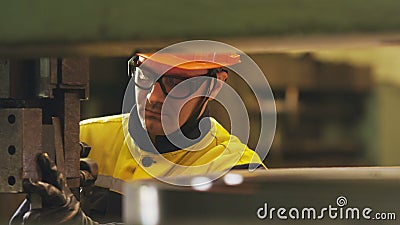 Motion past employee in glasses fixing machine tool stock footage
