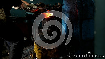 An old smithy, a blacksmith forging a metal part for engineering, a hot metal, a close-up, forge stock video