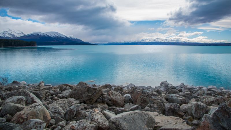 Lake Pukaki, New Zealand, stones, clouds, mountains, 4k (horizontal)